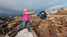 Oklahoma residents have returned to what remains of their homes after Monday's tornado killed at least  and destroyed countless homes while reducing one elementary school almost entirely to rubble, killing seven children.